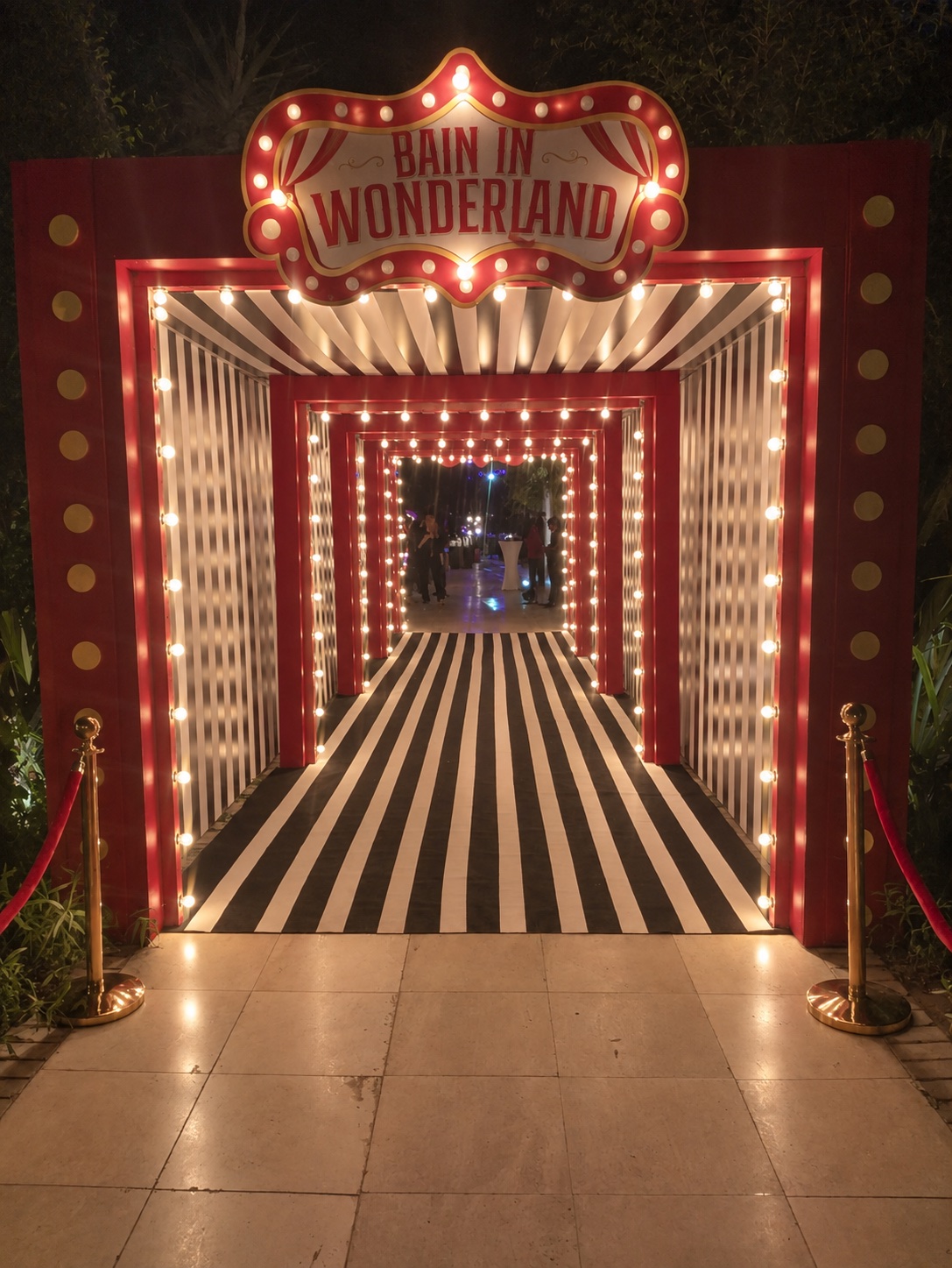 Bain in Wonderland experiential marquee entrance tunnel with bulb lighting