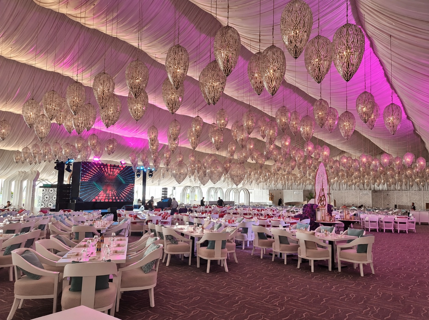 VIP Hospitality Marquee with hanging chandeliers and curved LED stage built by Morph